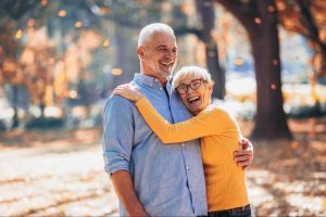 older couple laughing and embracing