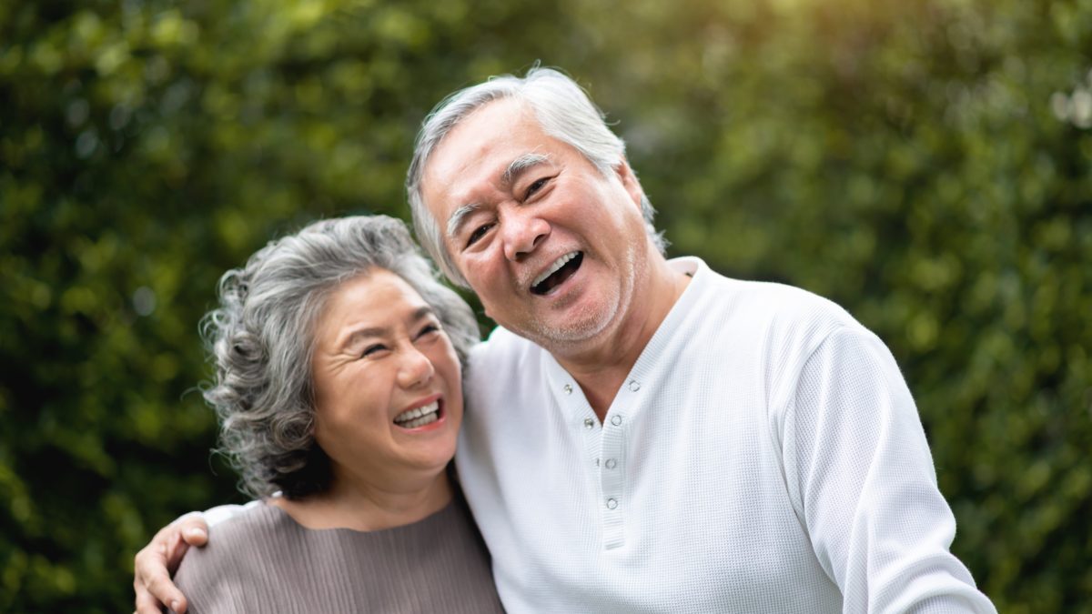Happy elderly couple laughing.
