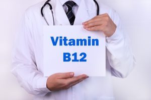 doctor holding sign that says vitamin B12