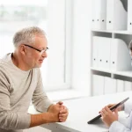 Man talking to doctor