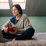 Menopausal woman sitting on bed