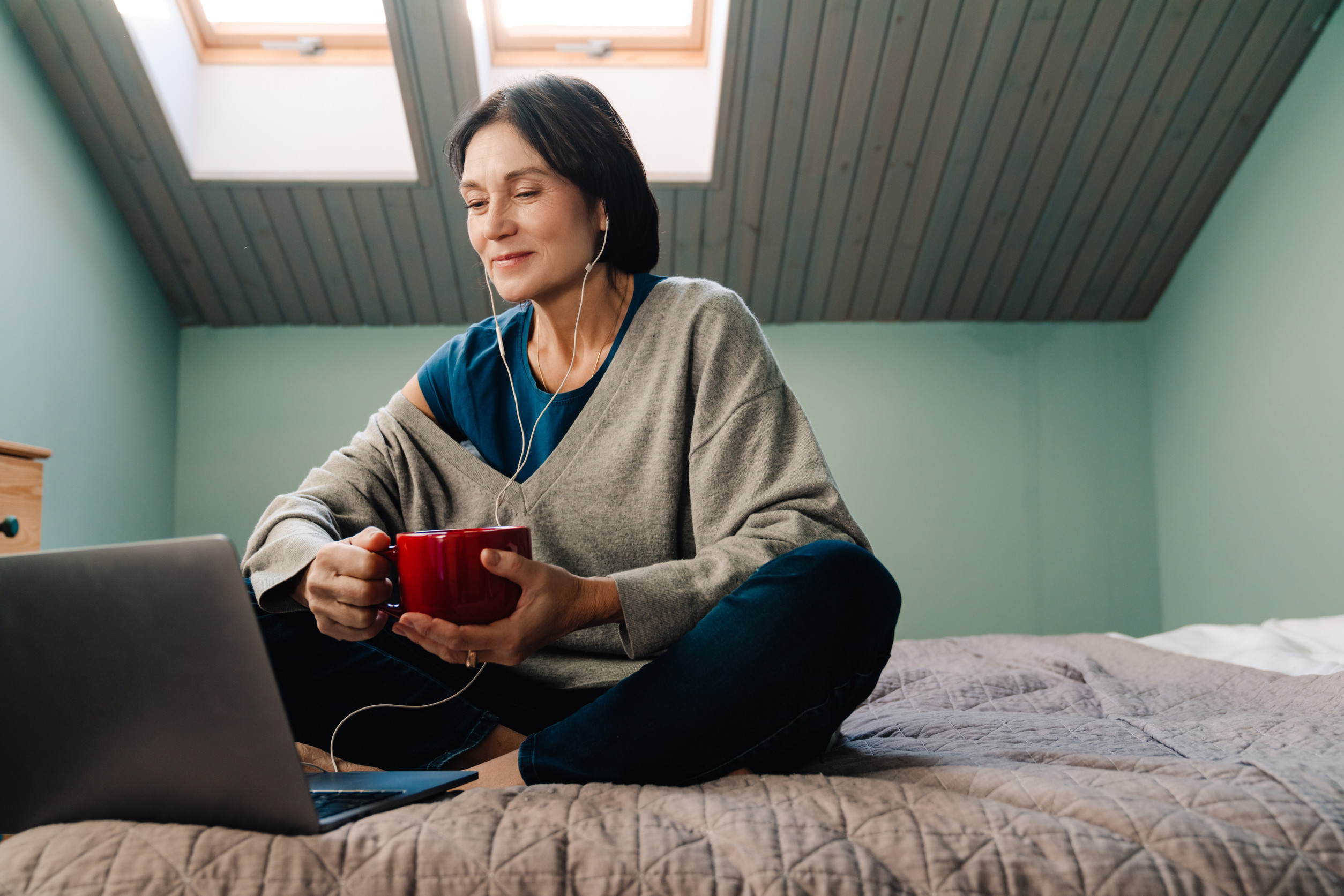 Menopausal woman sitting on bed